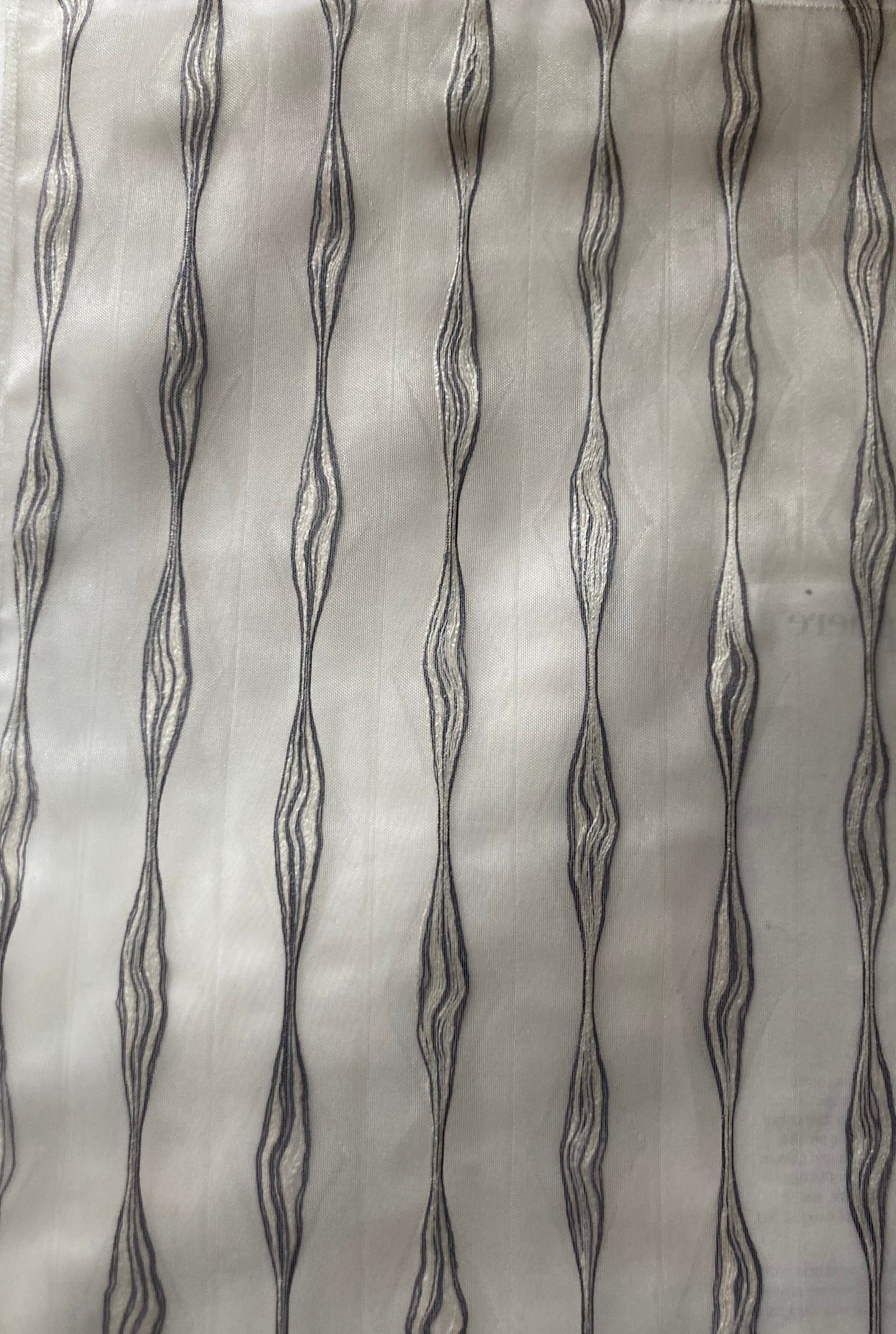 Embroidered Sheer fabric which allows light to filter through.