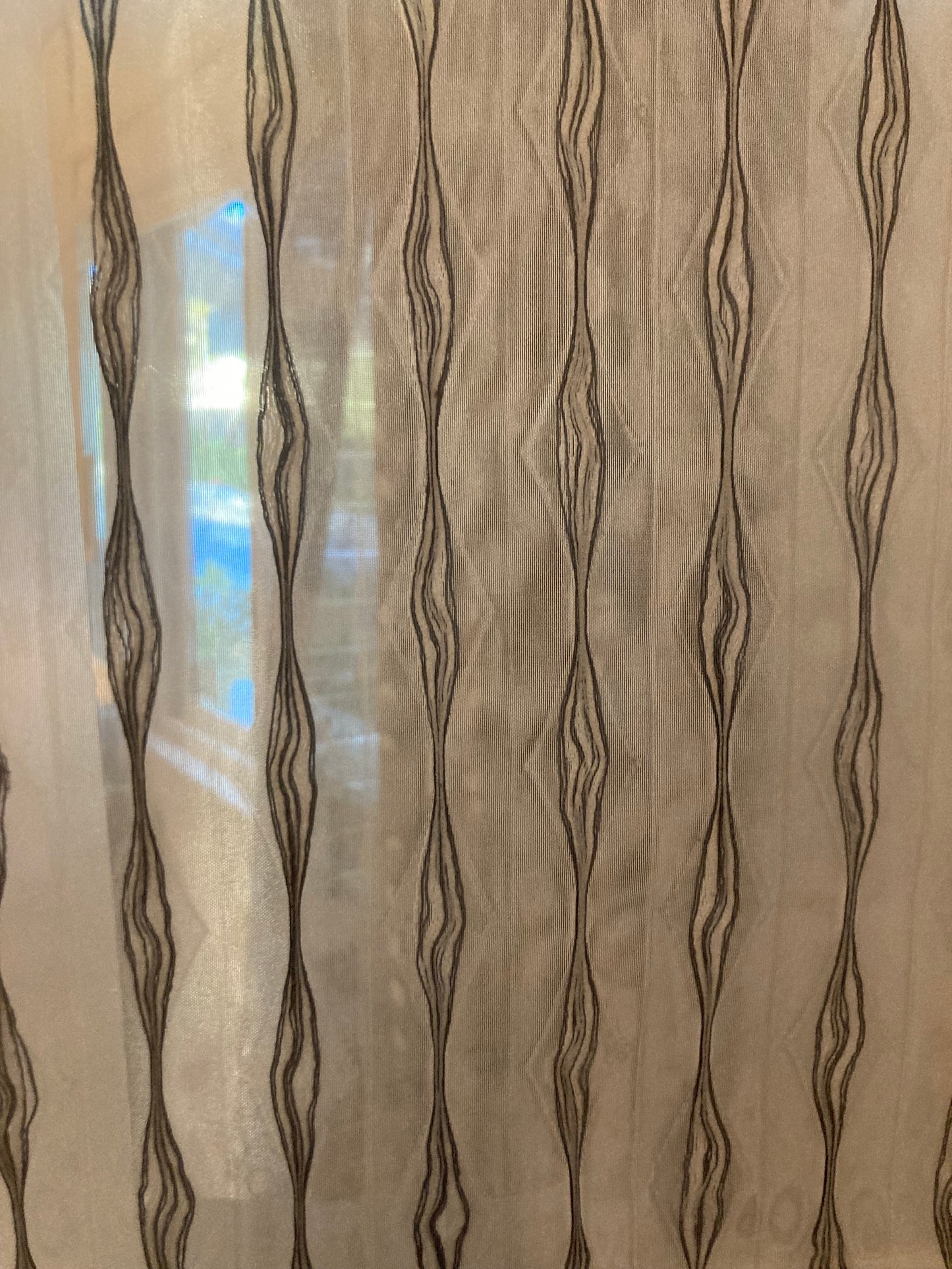 Embroidered Sheer fabric which allows light to filter through.