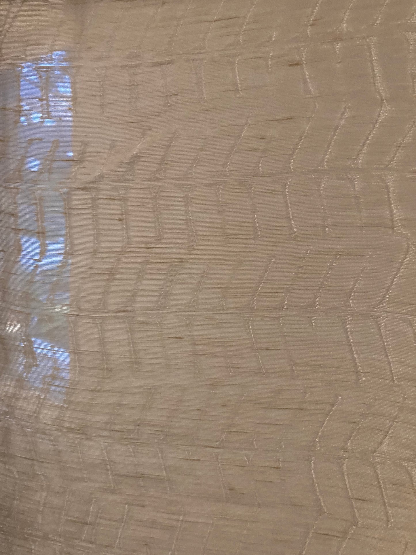 Sheer fabric with chevron motif. Sheer fabric allow light to filter through
