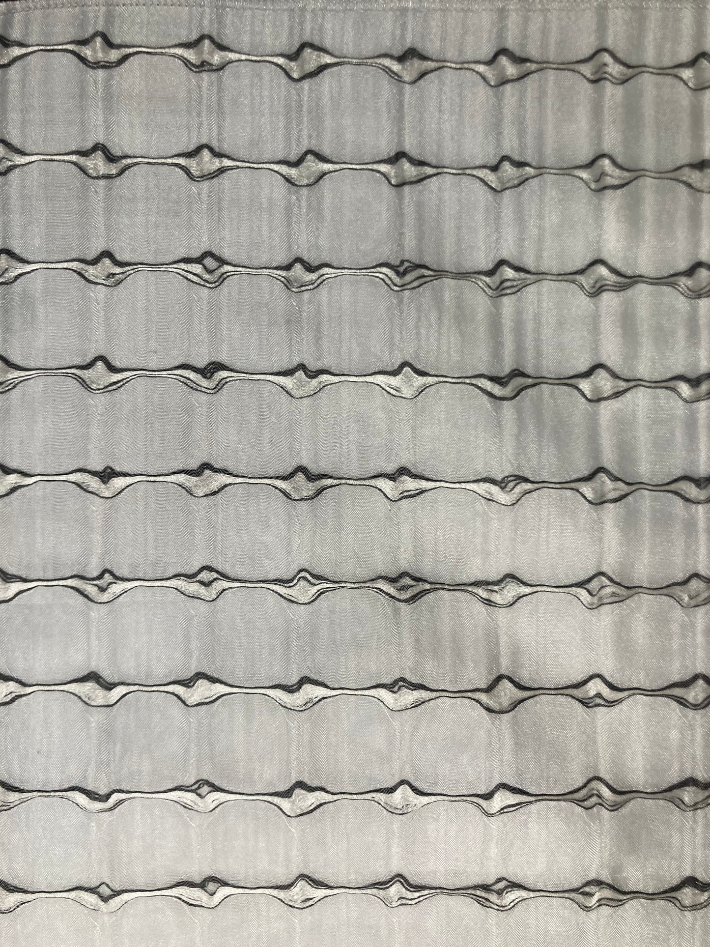 Silk Sheer fabric which allows light to filter through. Vertical striation in gray